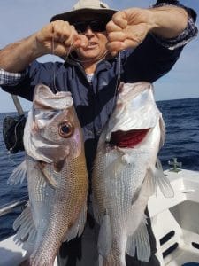 Man showing freshly caught sea fishes in Winter 2018